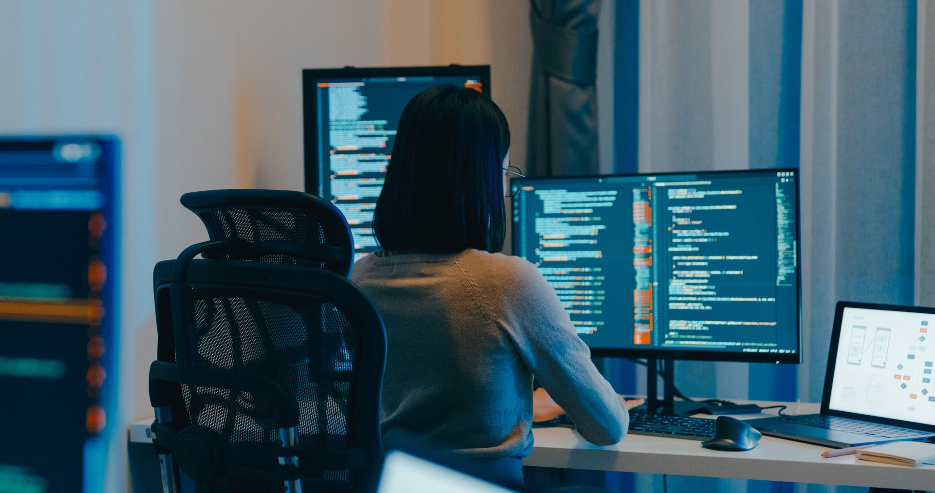 Young Asia female freelance eyeglasses typing write prompt AI bot IT app smart program nomad, video game, terminal with coding language, designer, big data center on computer in night office.